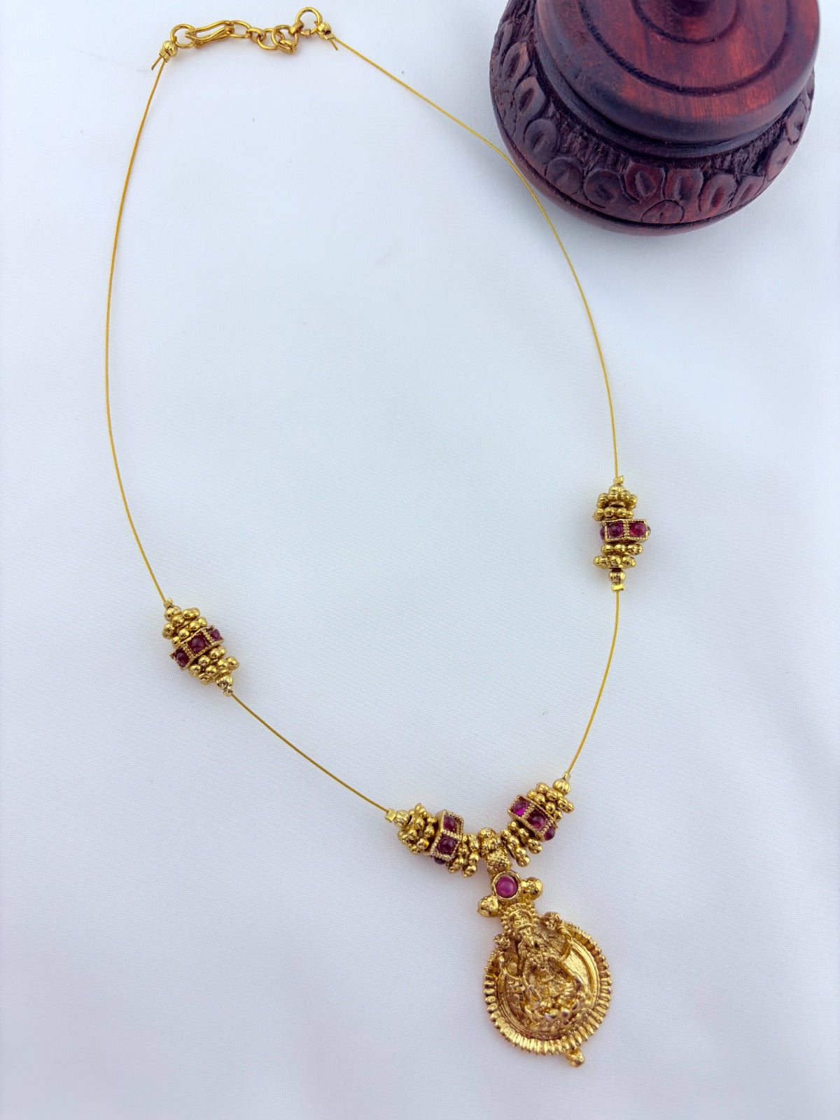 Premium invisible chain Lakshmi pendant adorned with classic stone balls and golden beads