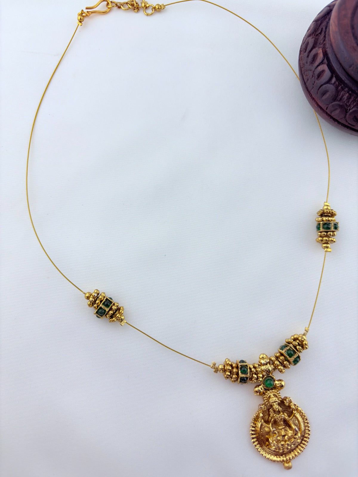 Premium invisible chain Lakshmi pendant adorned with classic stone balls and golden beads