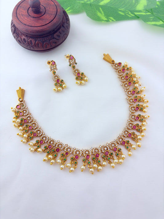 Premium matte finish neckset with classic ruby stones and pearl drops