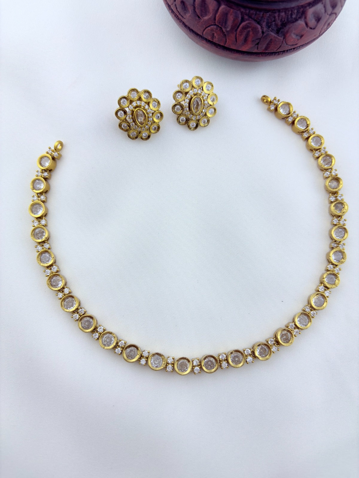 Classic traditional motifs with a trendy touch - Premium matte finish AD stone necklace with matching studs