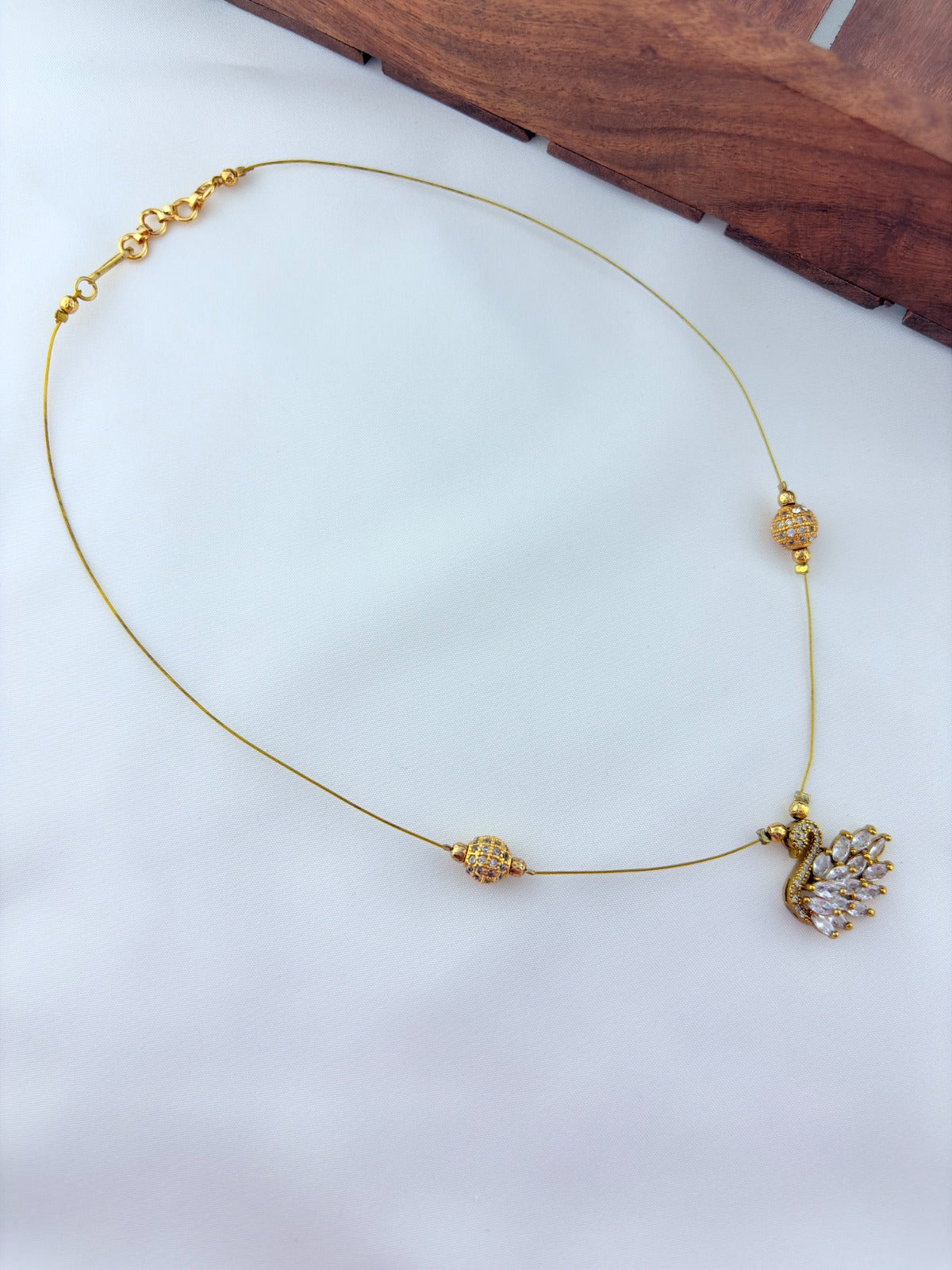 Premium invisible  chain adorned with AD stone balls and CZ stone duck pendant