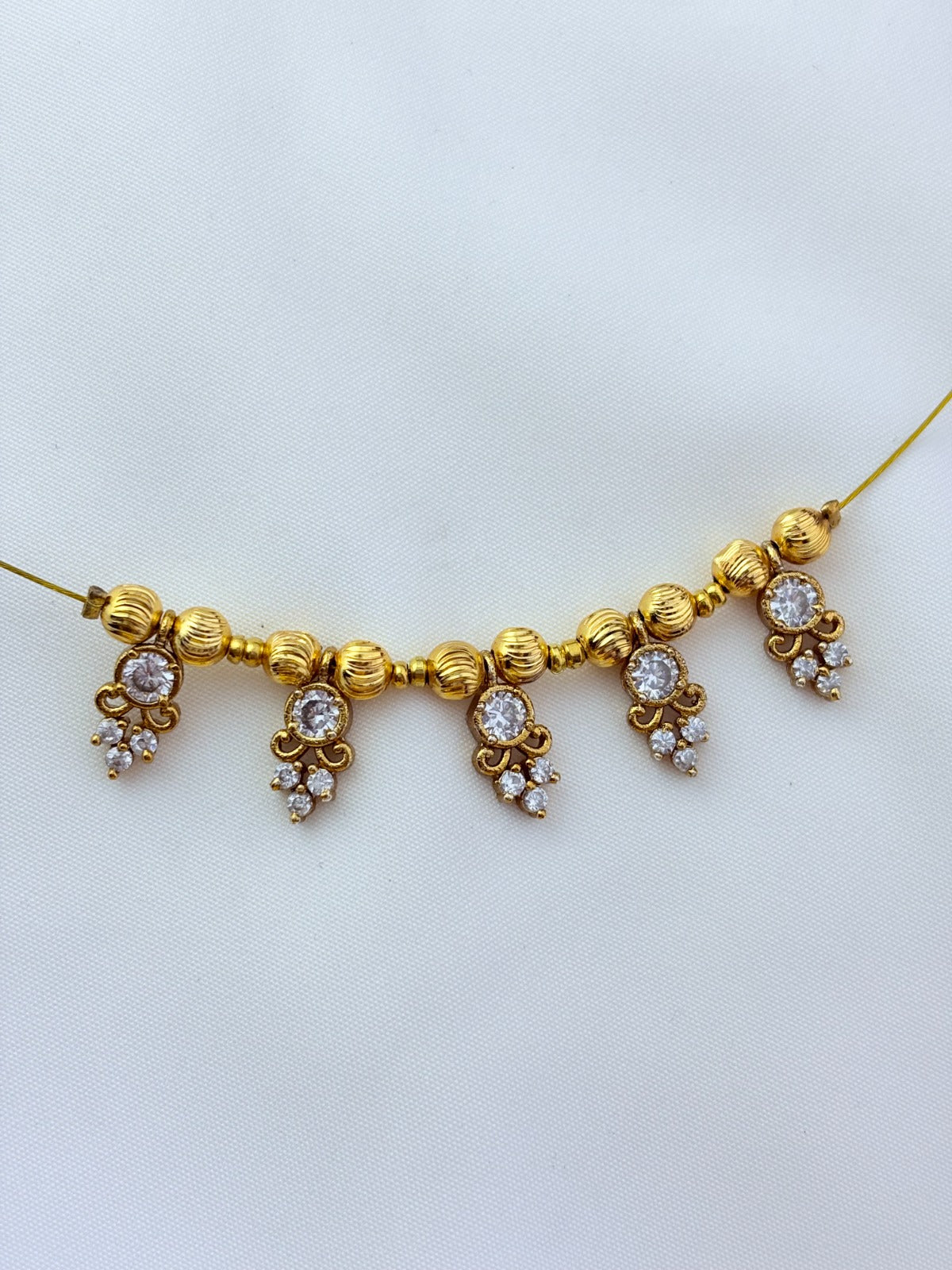 Premium invisible chain and matching earrings adorned with AD stone drops