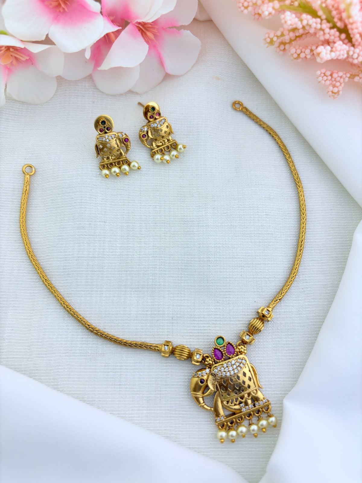 Premium matte finish elephant pendant neckset adorned with AD stones and pearl drops