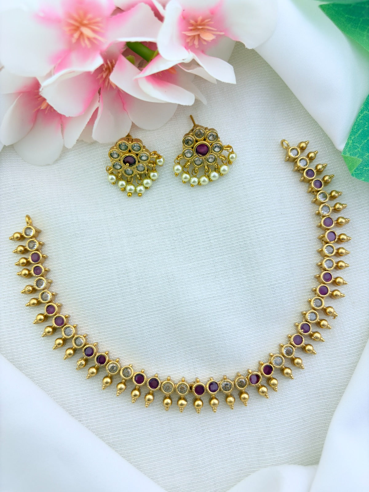 Premium matte finish AD necklace and earrings beautifully crafted with pearl dorps