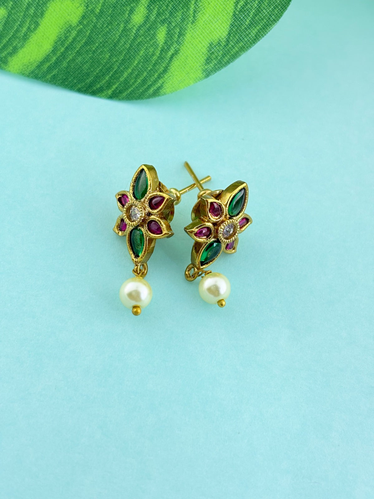 Premium antique finish necklace showcasing classic rich ruby and green stones with a Lakshmi pendant and matching earrings