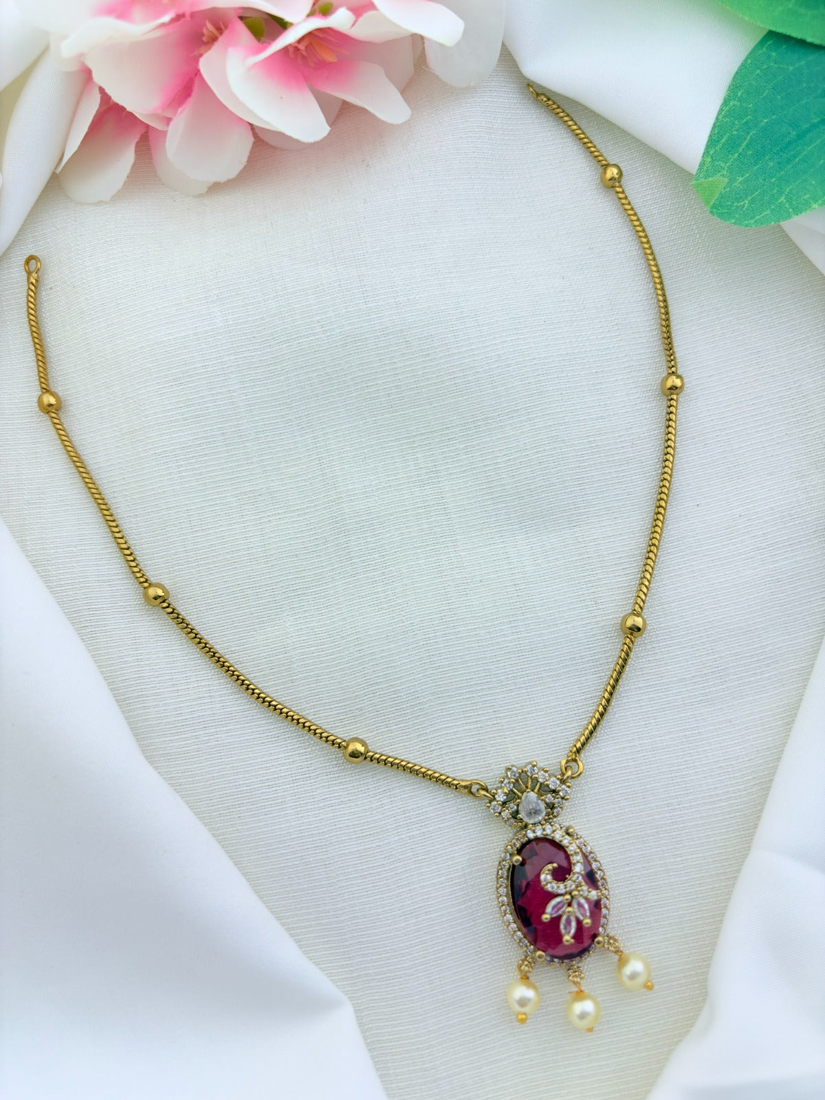 Premium matte finish chain beautifully crafted ruby stone pendant adorned with CZ stones and pearl drops