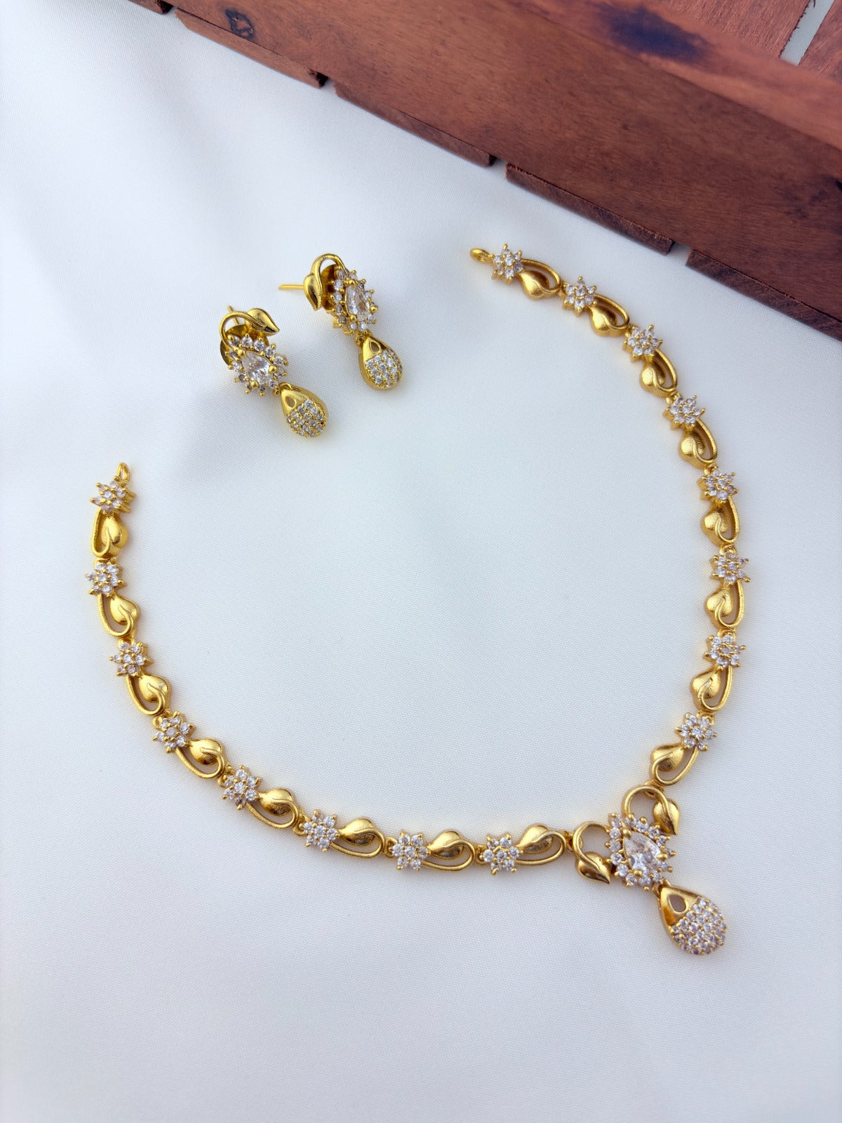 Elegant AD stone necklace in premium matte finish with matching earrings