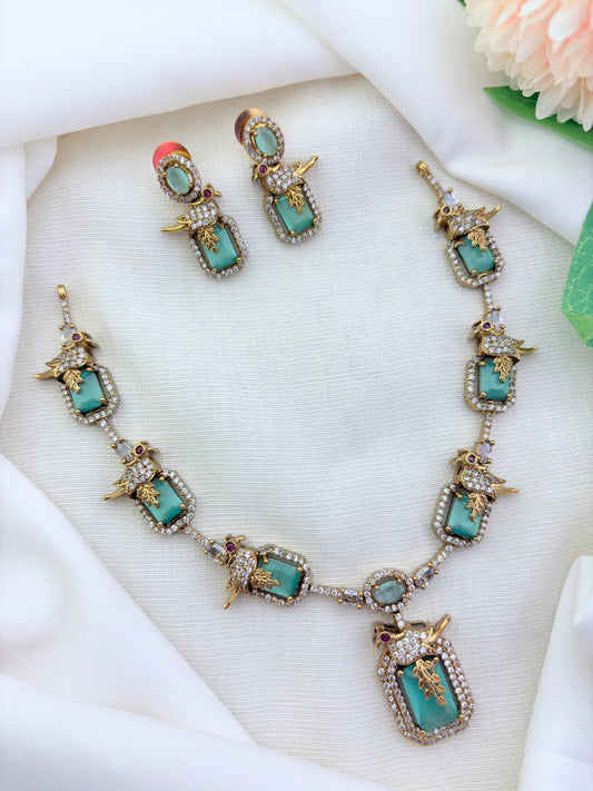 Stylish peacock pattern necklace featuring classic stones in premium matte finish with matching earrings