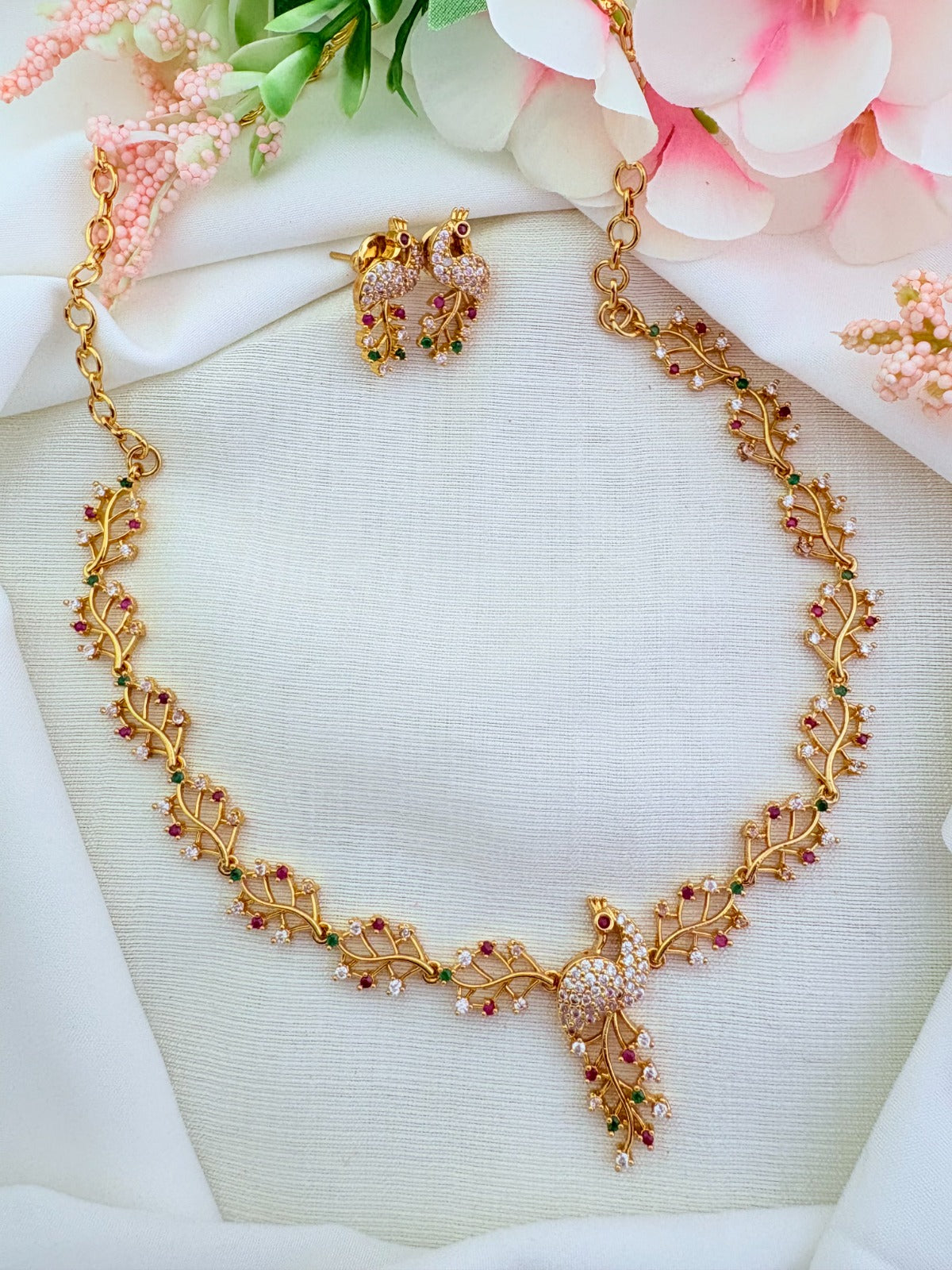 Traditional peacock pattern necklace and matching earrings in micro gold polish adorned with AD stones