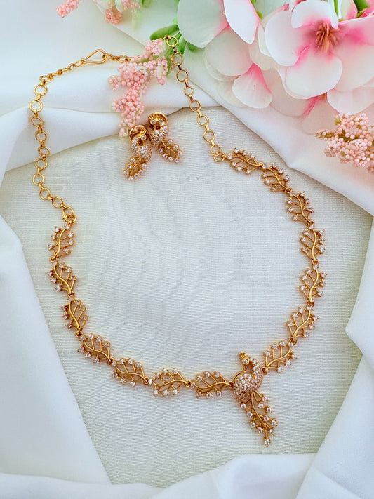 Traditional peacock pattern necklace and matching earrings in micro gold polish adorned with AD stones