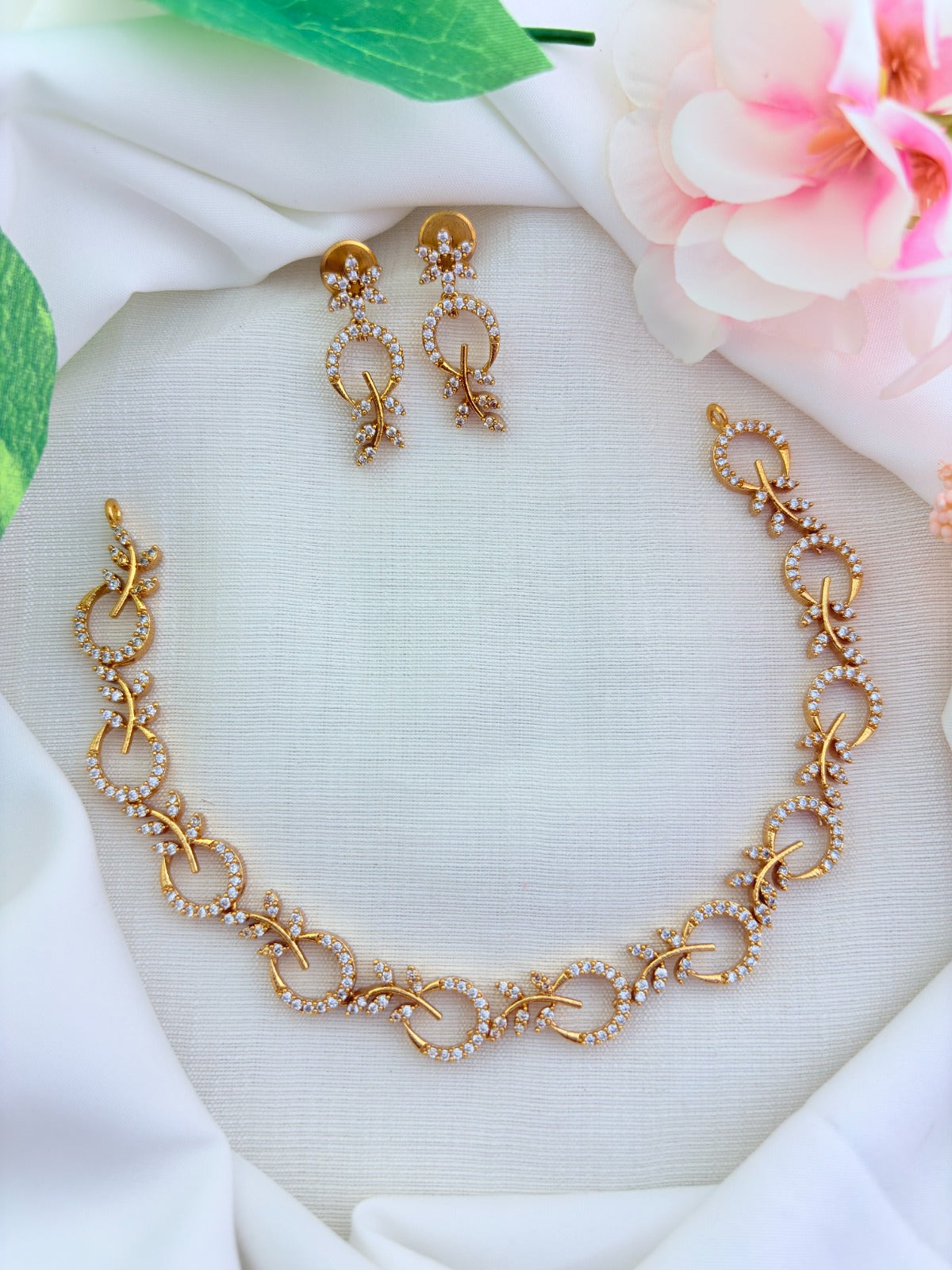 Beautifully crafted Premium matte finish necklace and earrings adorned with AD stones