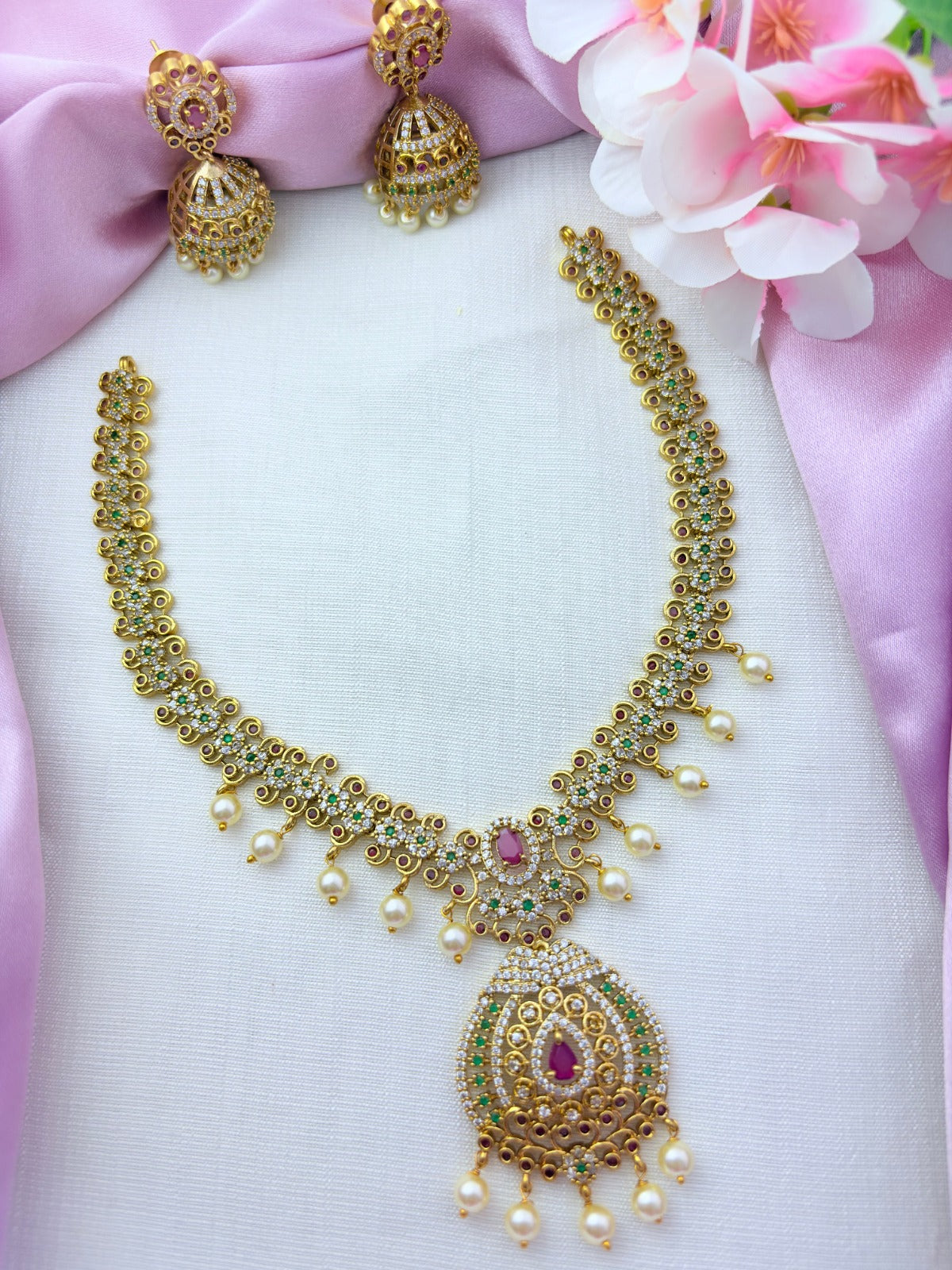 Elegant premium matte finish necklace and jhumka beautifully crafted with classic stones and pearl drops