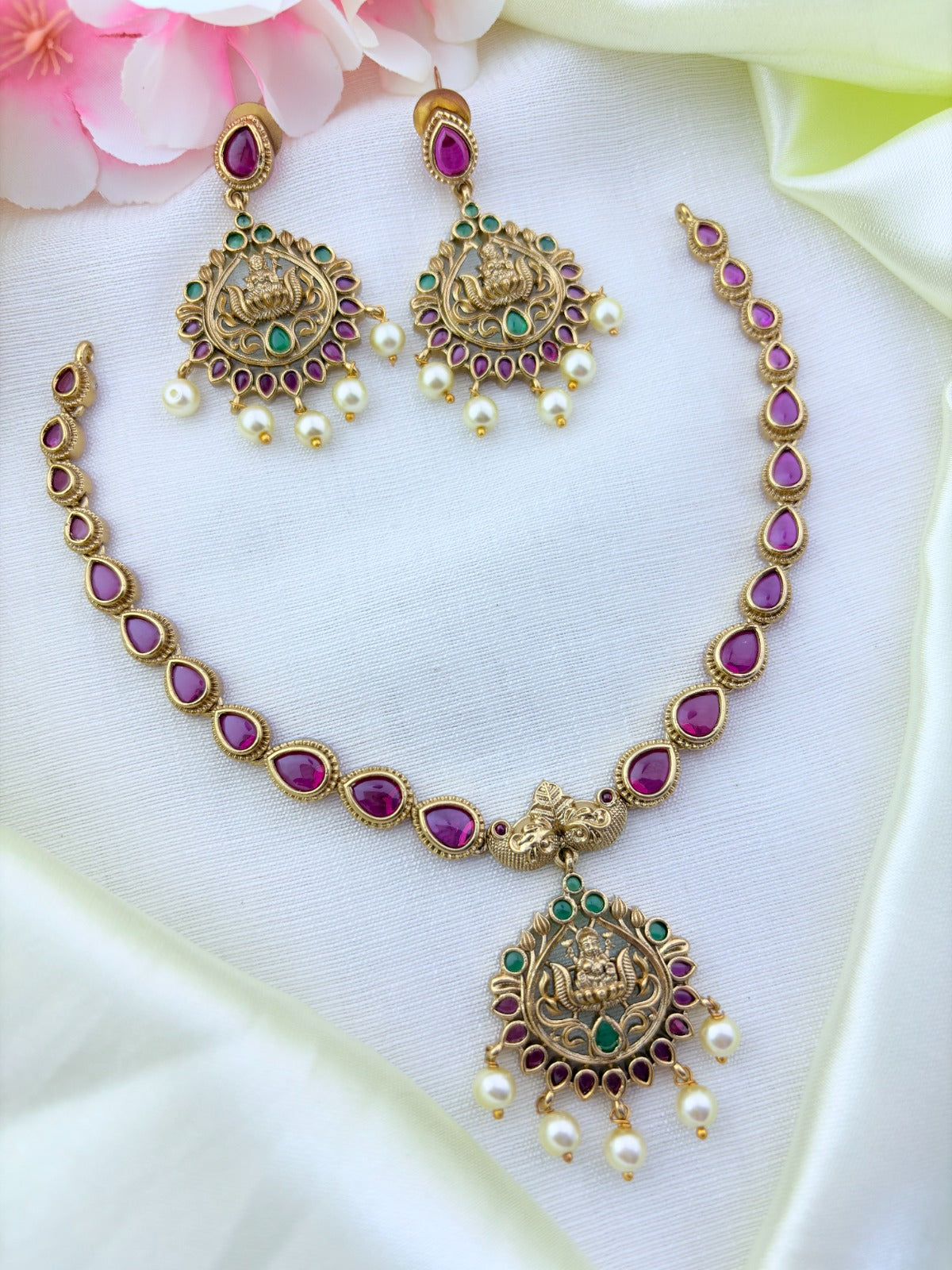 Timeless matte finish lakshmi pendant necklace enhanced with classic stones and pearl drops