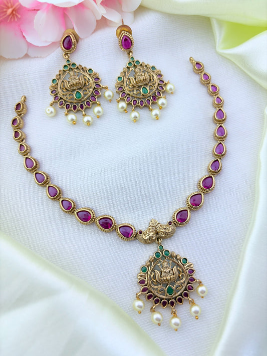 Timeless matte finish lakshmi pendant necklace enhanced with classic stones and pearl drops