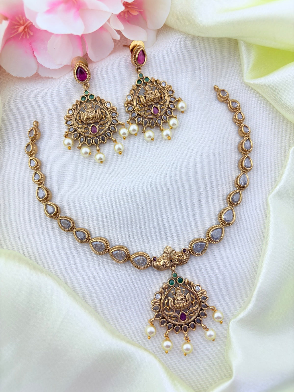 Timeless matte finish lakshmi pendant necklace enhanced with classic stones and pearl drops