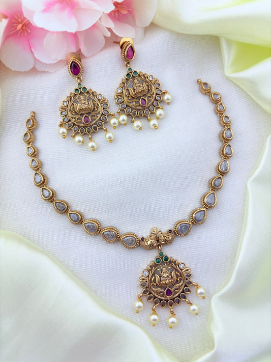 Timeless matte finish lakshmi pendant necklace enhanced with classic stones and pearl drops