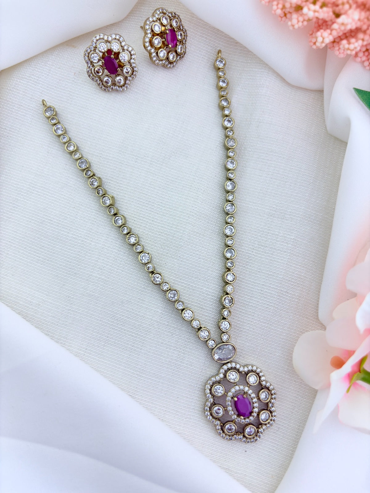 Elegant premium matte finish floral pendant necklace and matching earrings adorned wtih CZ stones