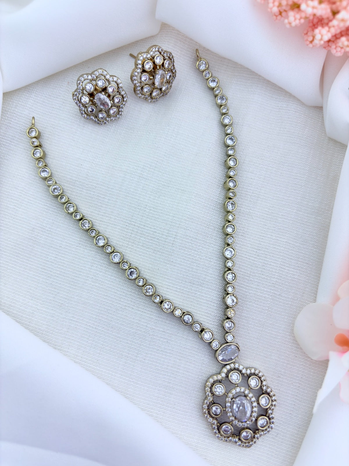 Elegant premium matte finish floral pendant necklace and matching earrings adorned wtih CZ stones