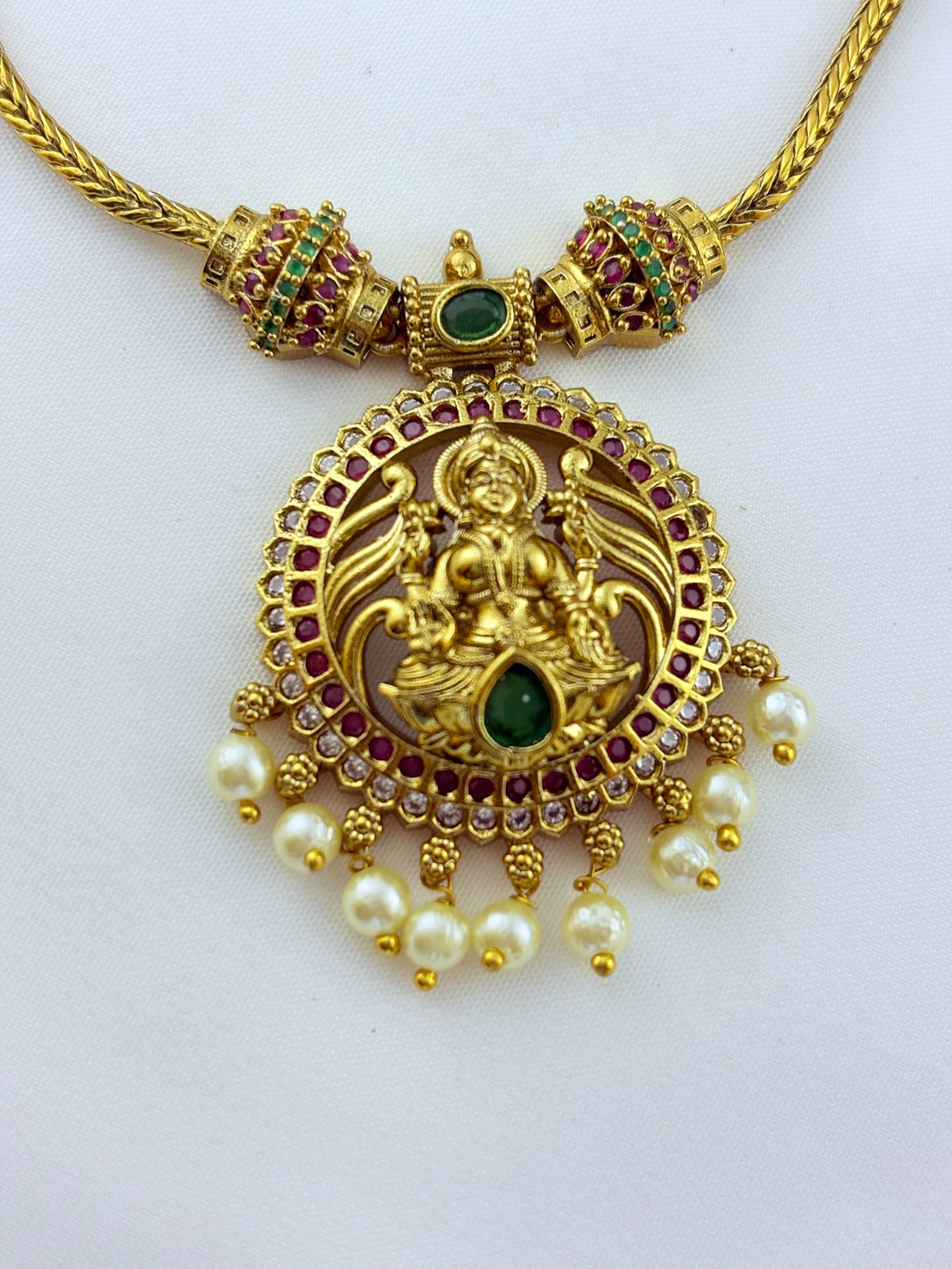 Traditional lakshmi pendant with matching jumkha beautifully designed with classic stones and pearl drops