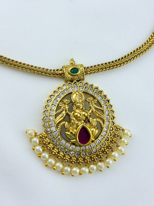 Traditional lakshmi pendant with matching jumkha beautifully designed with classic stones and pearl drops