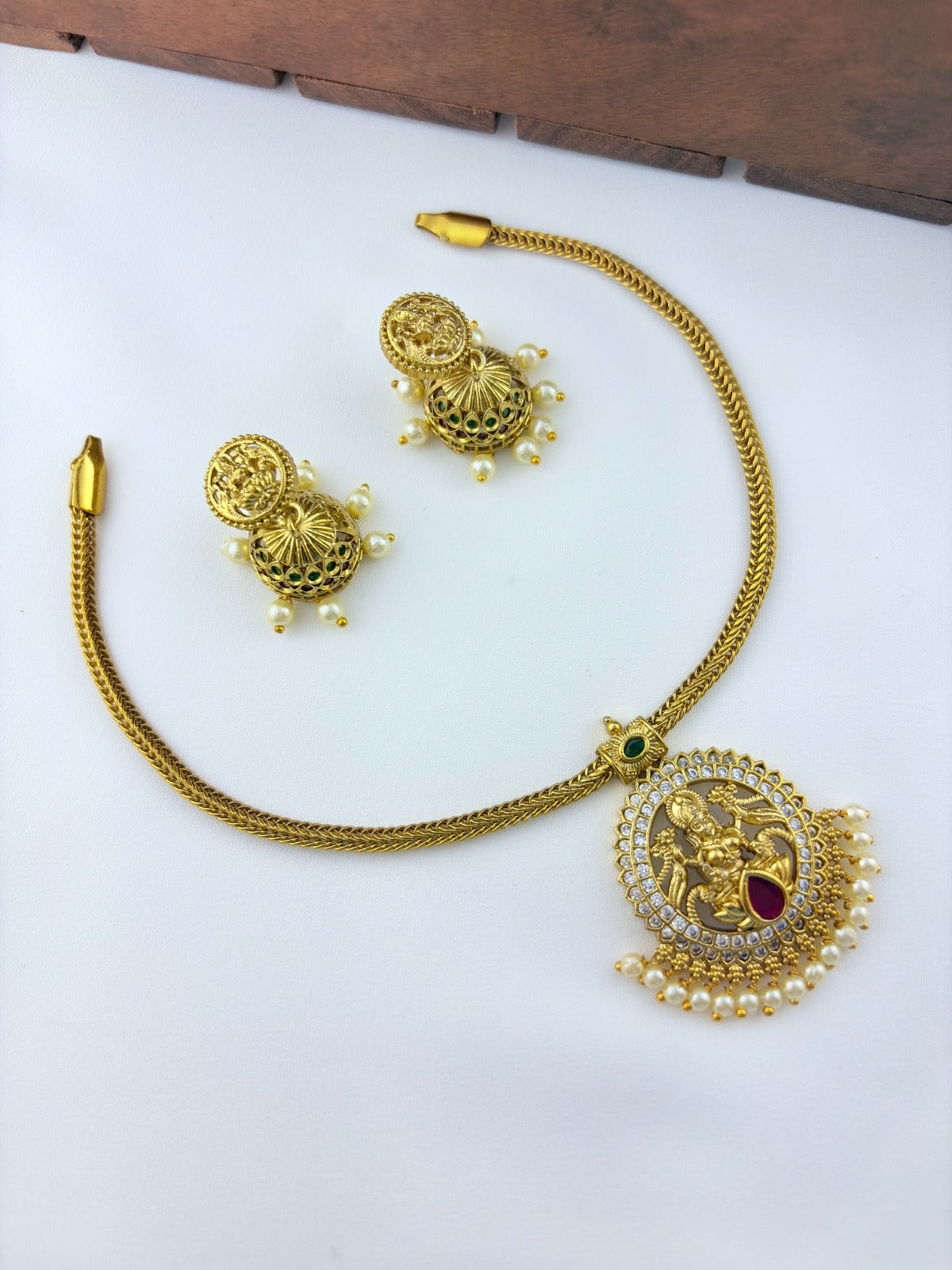 Traditional lakshmi pendant with matching jumkha beautifully designed with classic stones and pearl drops