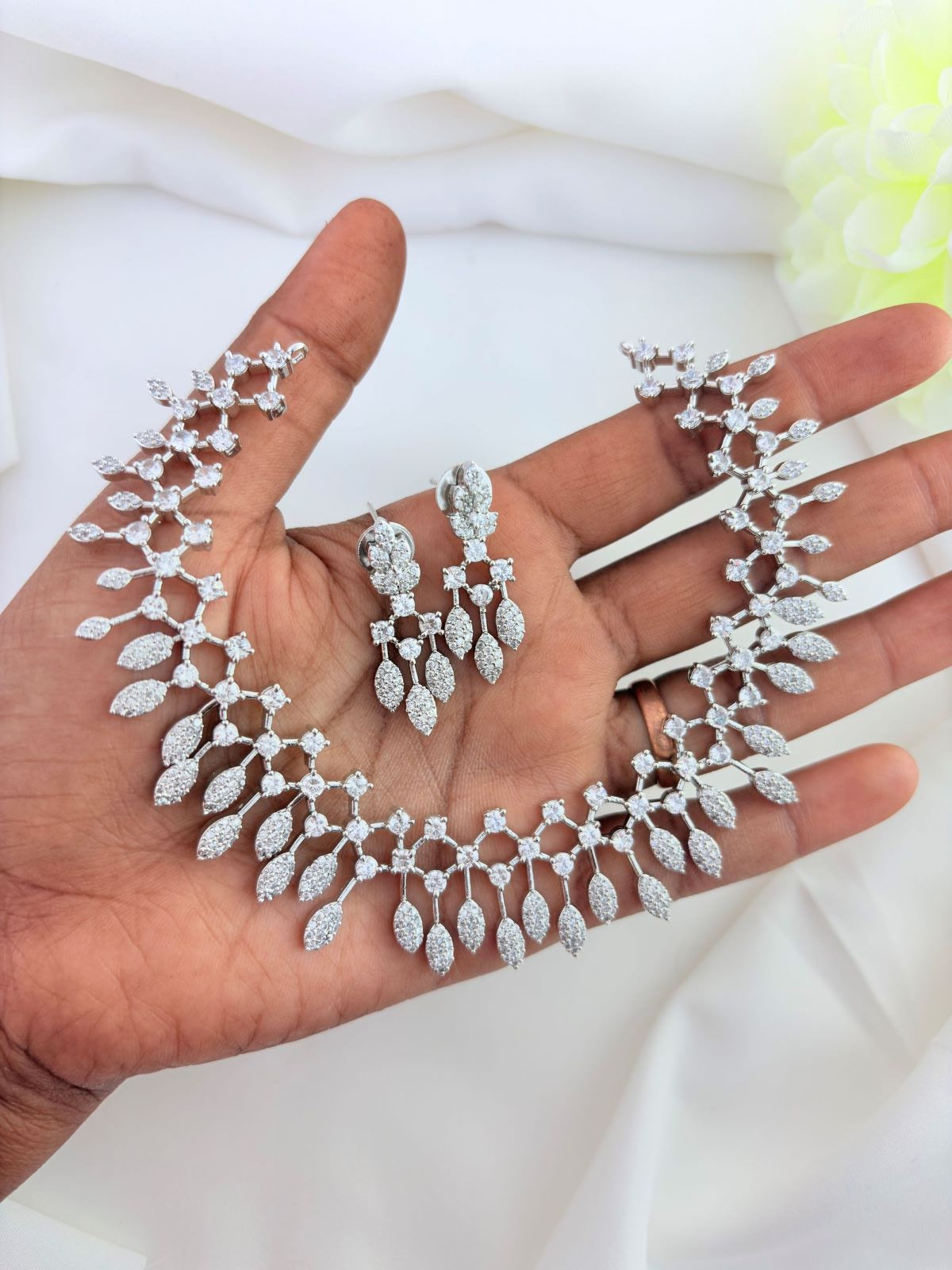 Trending pattern in premium silver polish AD neckset with matching earrings