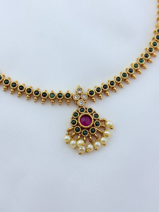 Elegant necklace and earrings crafted with classic kemp stones adorned with pearl drops