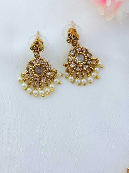 Elegant necklace and earrings crafted with classic kemp stones adorned with pearl drops