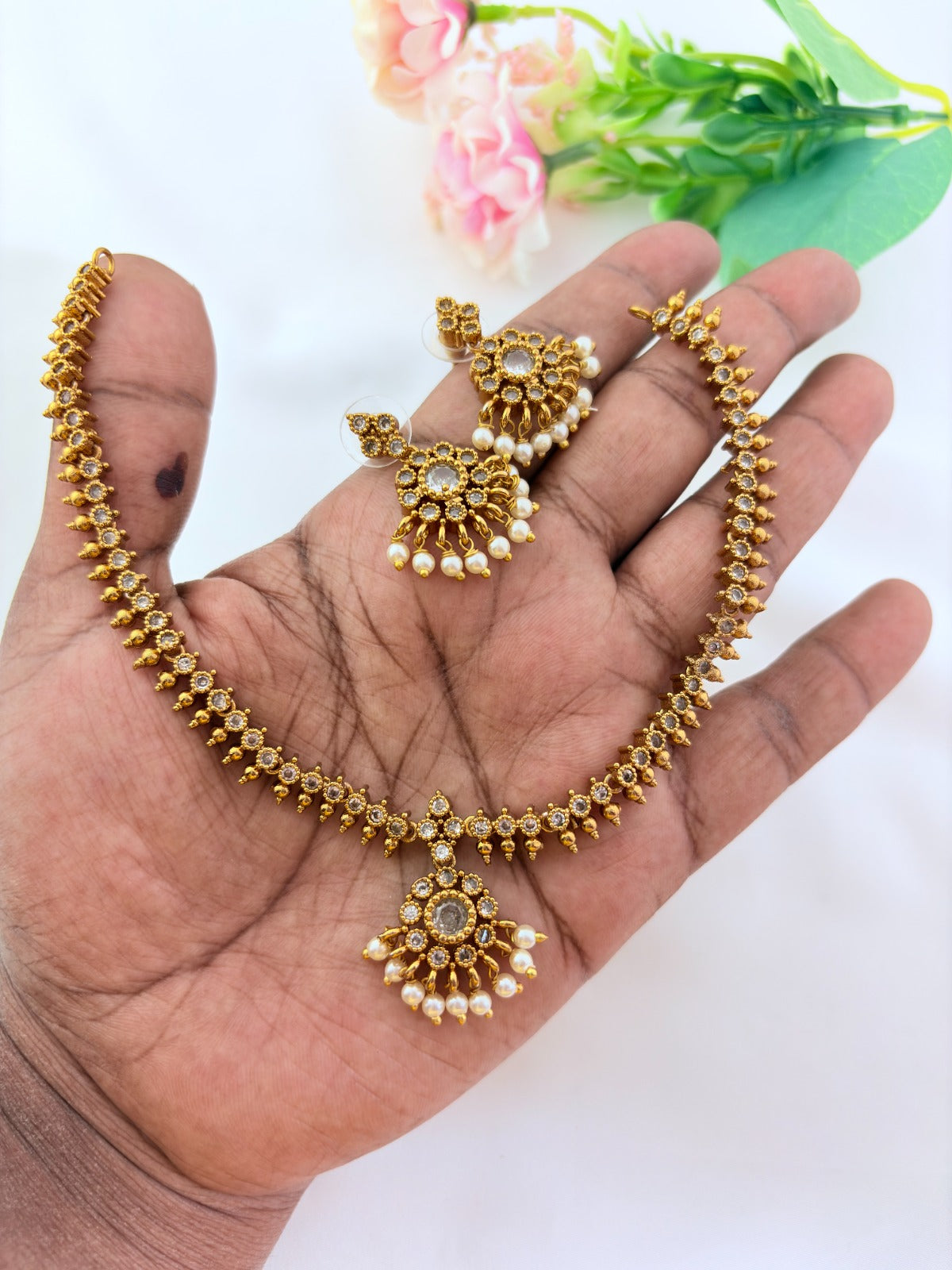 Elegant necklace and earrings crafted with classic kemp stones adorned with pearl drops