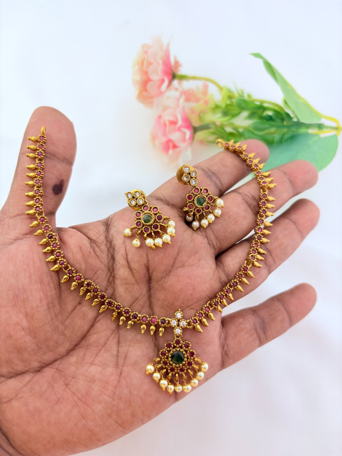 Elegant necklace and earrings crafted with classic kemp stones adorned with pearl drops