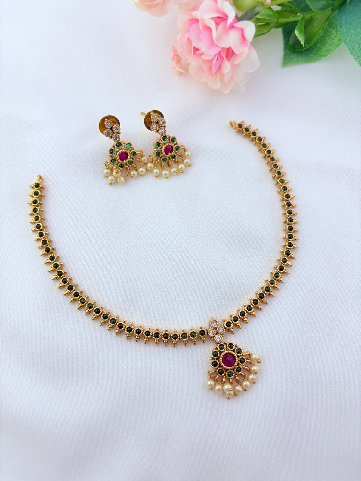 Elegant necklace and earrings crafted with classic kemp stones adorned with pearl drops