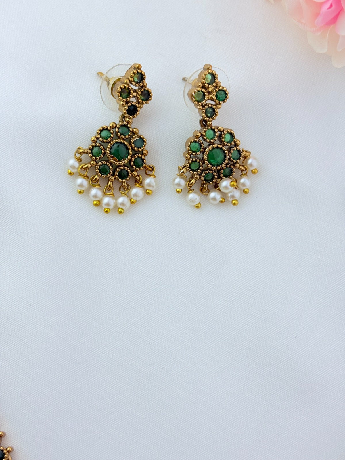 Elegant necklace and earrings crafted with classic kemp stones adorned with pearl drops