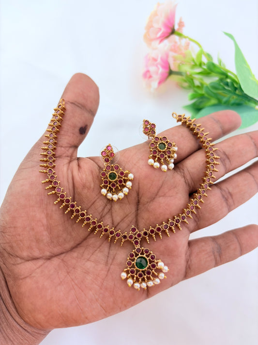 Elegant necklace and earrings crafted with classic kemp stones adorned with pearl drops