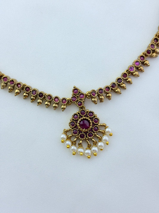 Elegant necklace and earrings crafted with classic kemp stones adorned with pearl drops