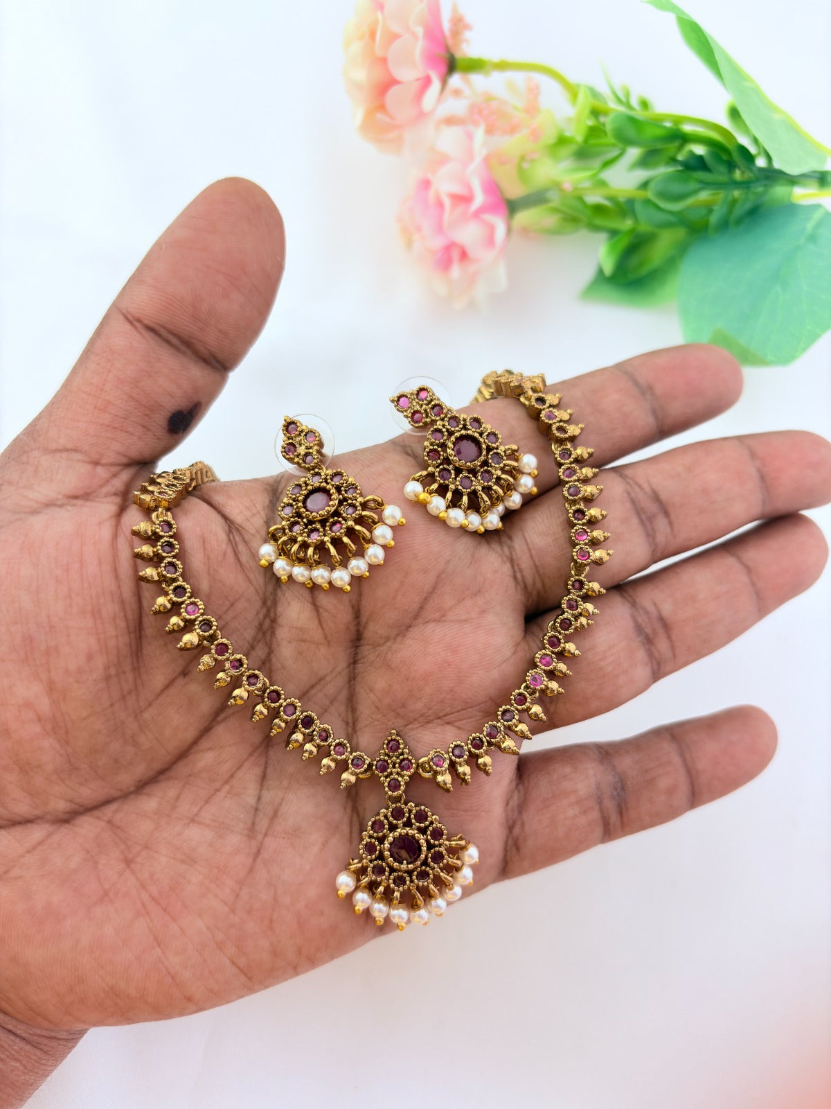 Elegant necklace and earrings crafted with classic kemp stones adorned with pearl drops