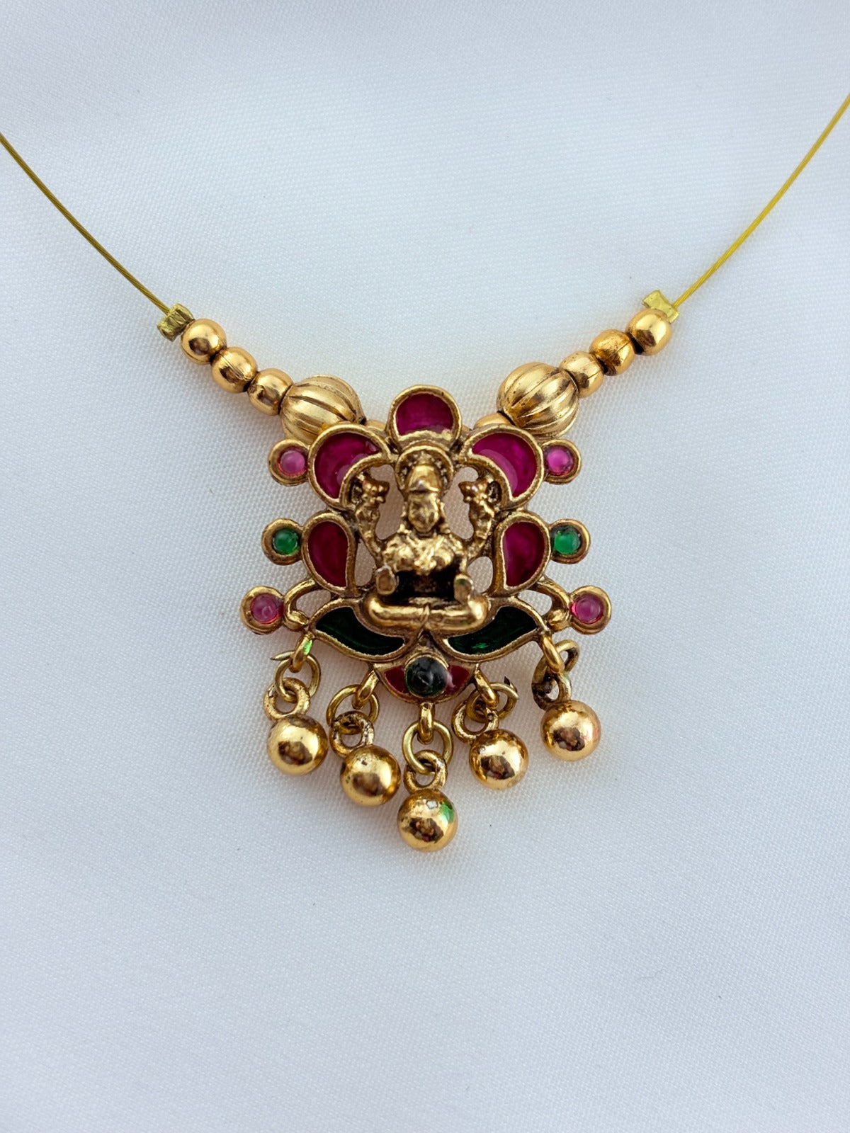 Trendy invisible chain with divine touch - Lakshmi pendant  and matching stud adorned with golden beads