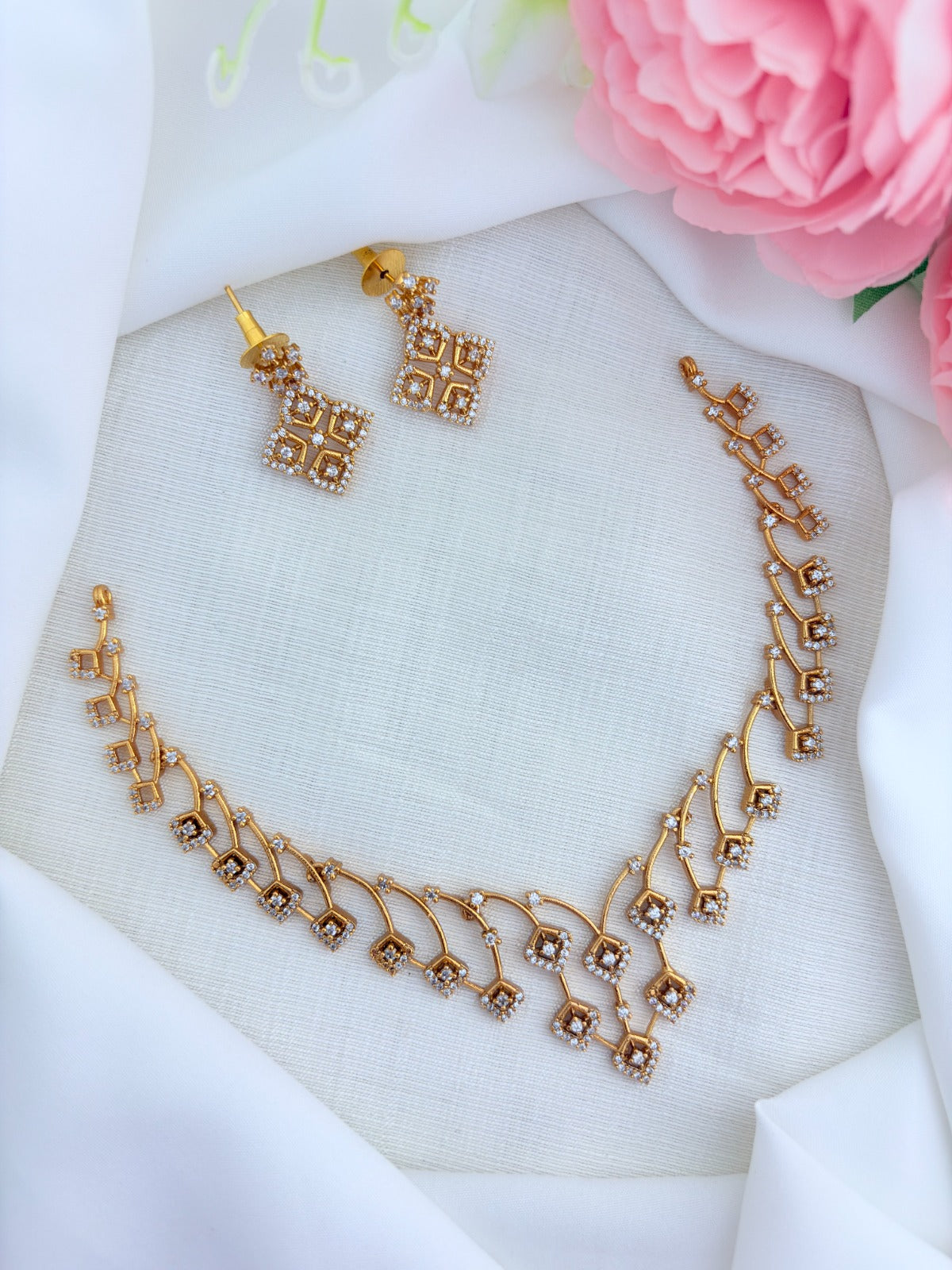 Modern elegance in a short silhouette - Premium matte finish neckset and earrings adorned with AD stones