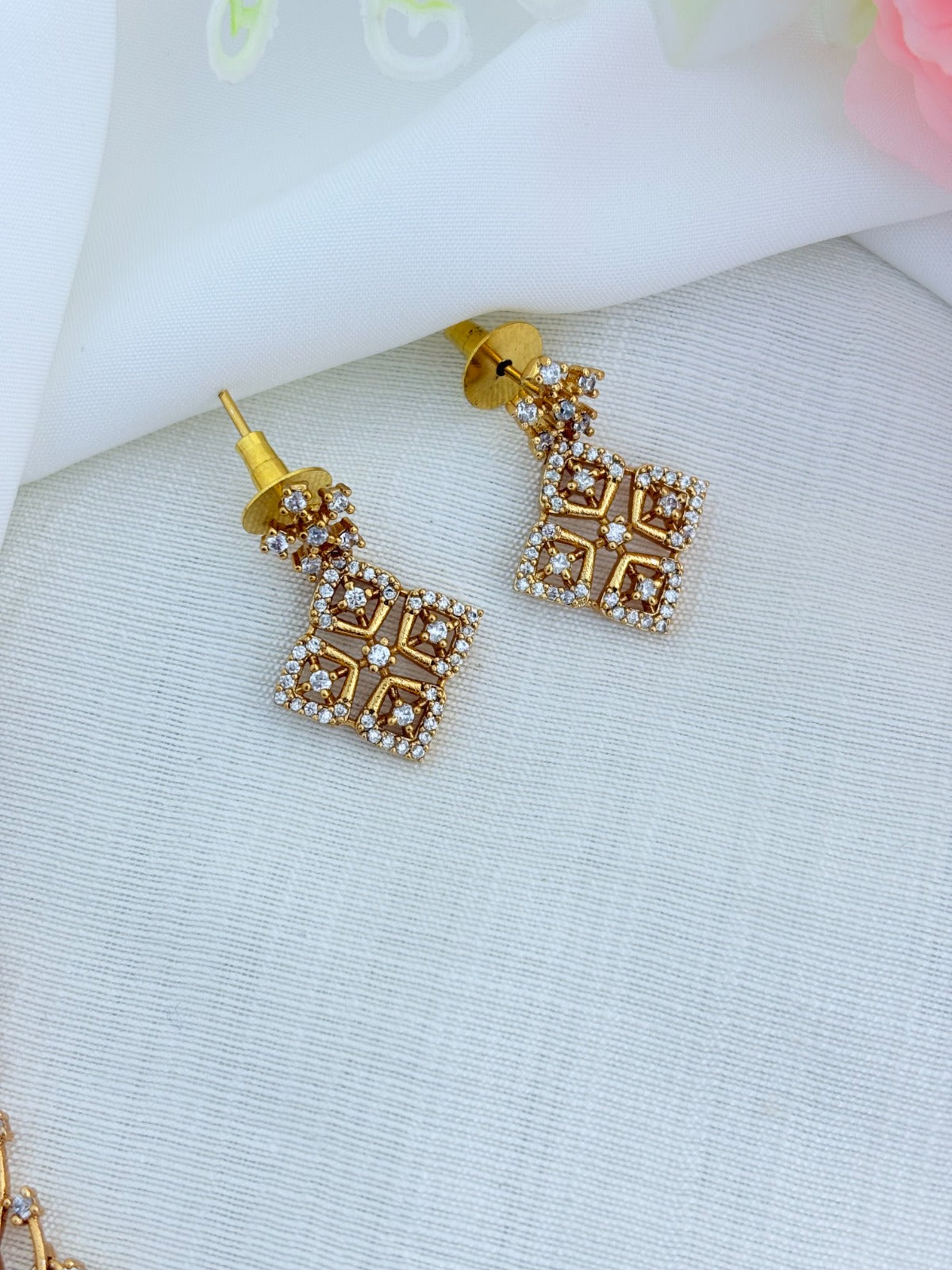 Modern elegance in a short silhouette - Premium matte finish neckset and earrings adorned with AD stones