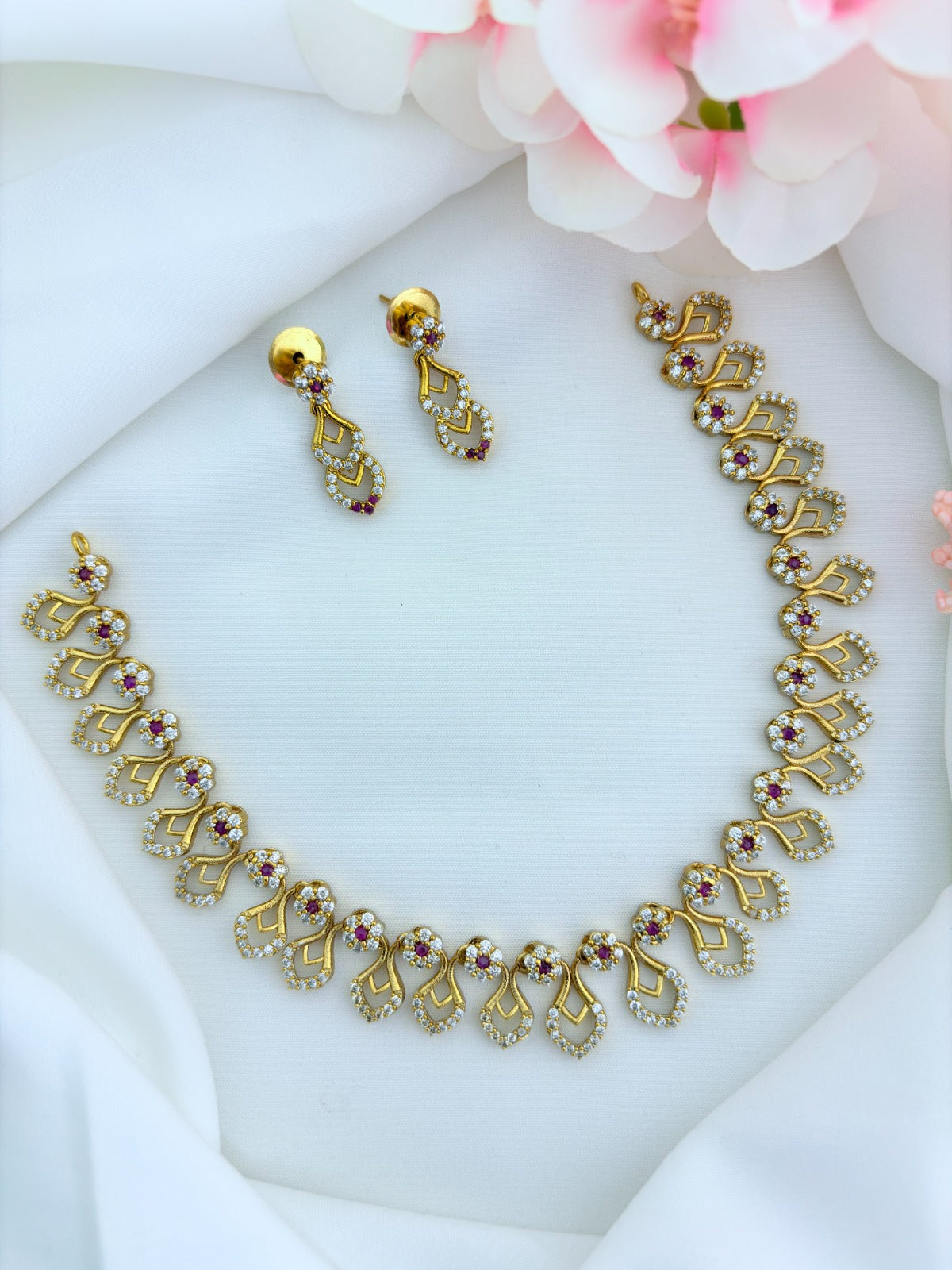 Premium matte finish necklace and earrings adorned with classic AD stones