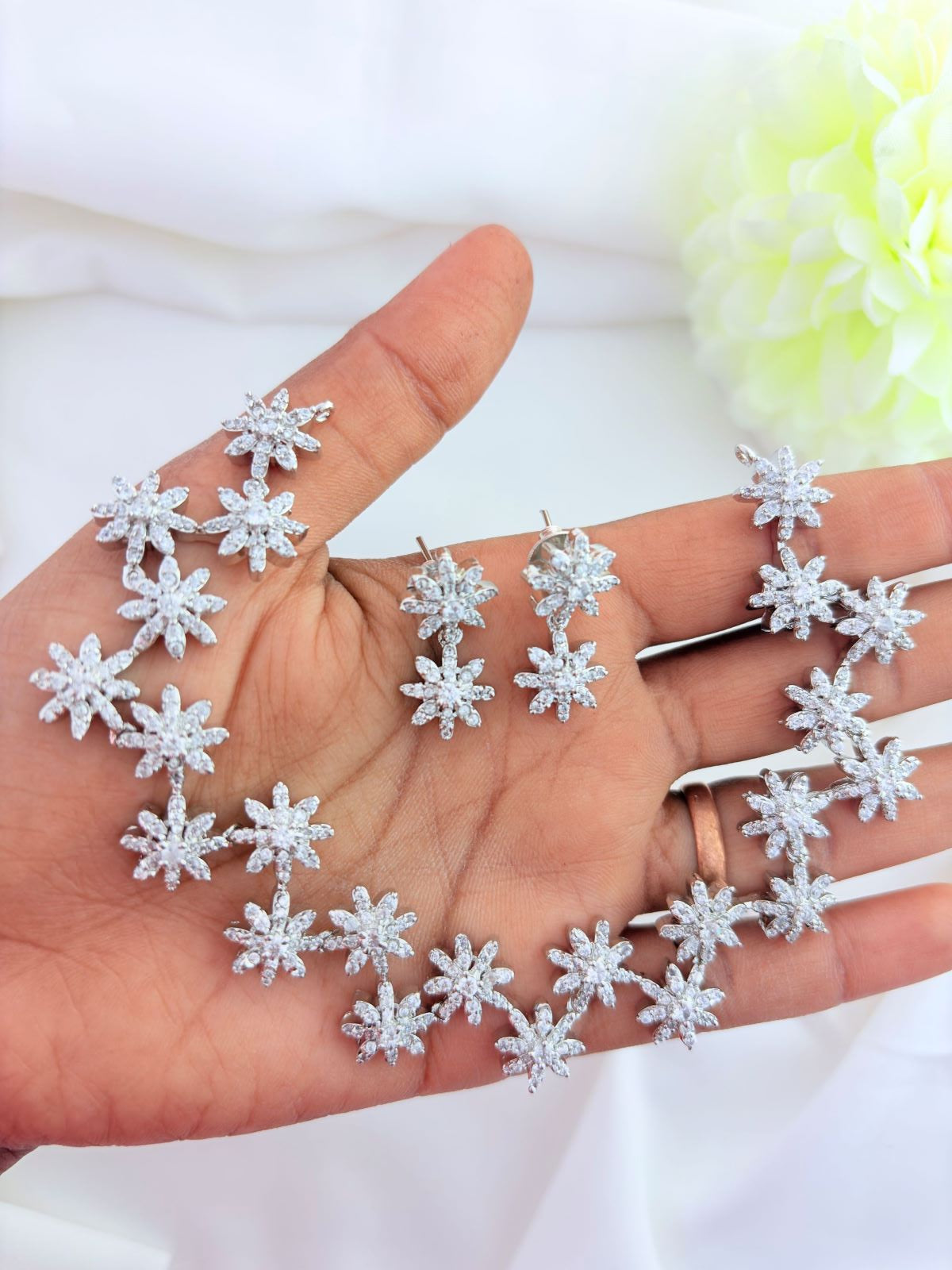 Floral Pattern AD stone neckset in premium silver polish with matching earrings