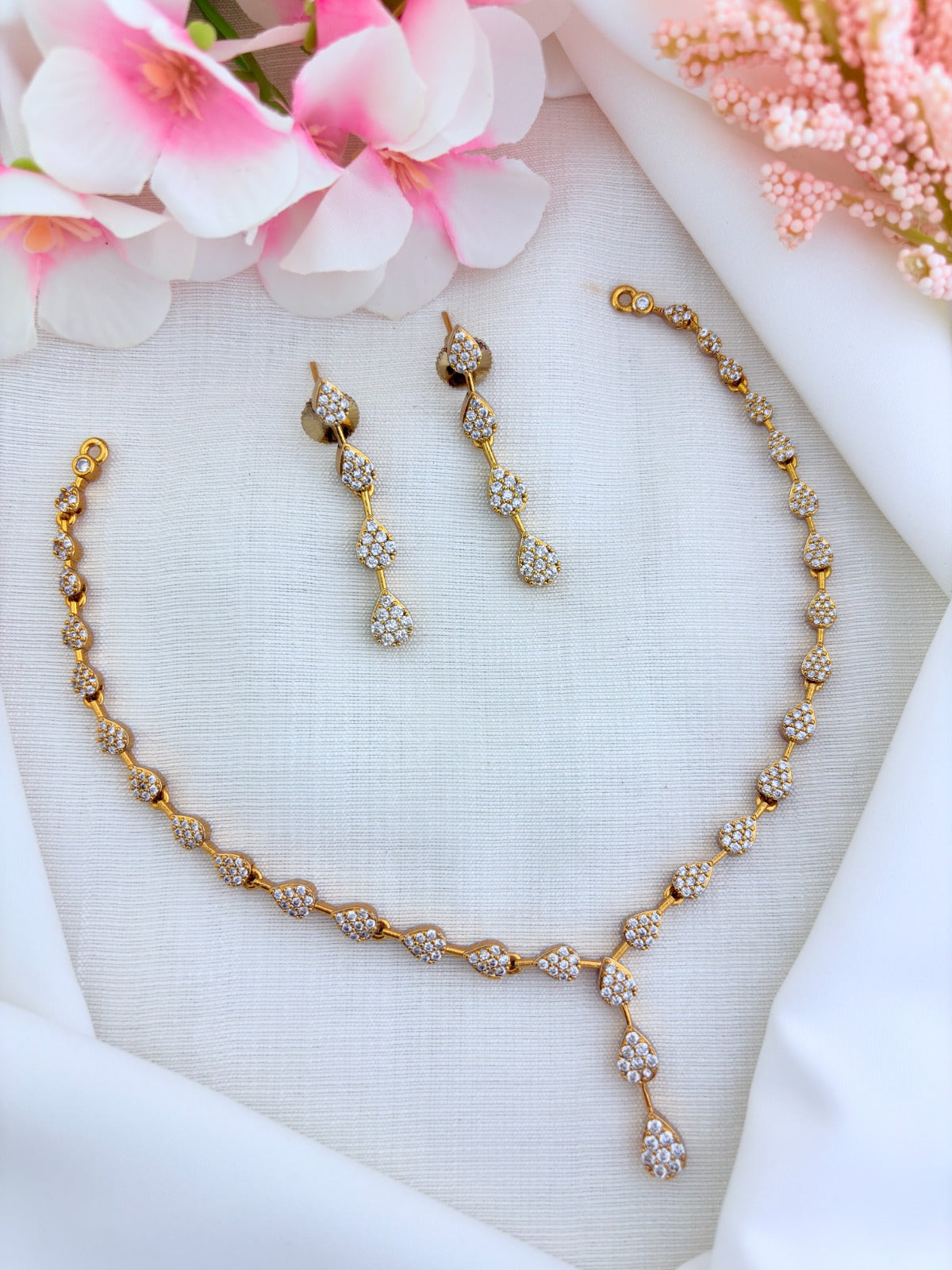 Style in modern tradition - Premium matte finish necklace and matching earrings adorned with AD stones