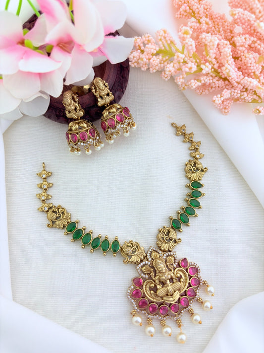 Premium matte finish Lakshmi pendant necklace beautifully crafted with classic ruby,green stones and pearl drops
