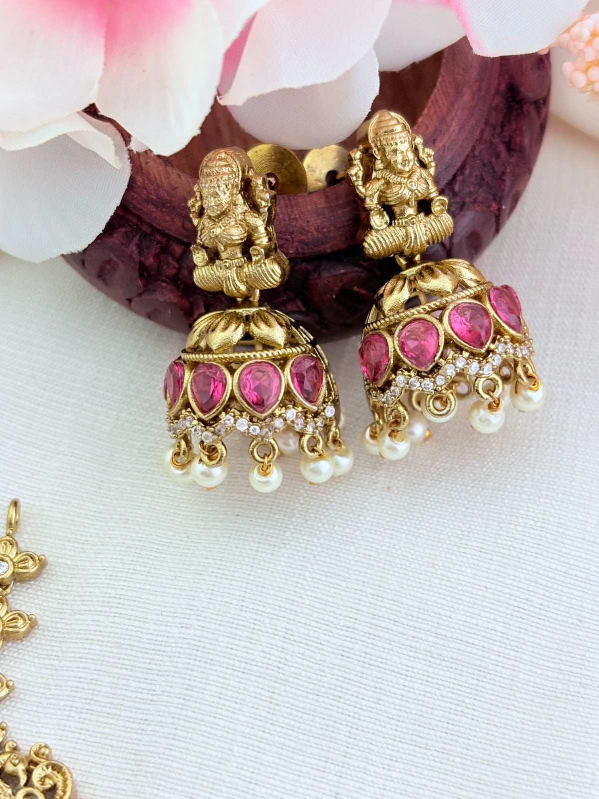 Premium matte finish Lakshmi pendant necklace beautifully crafted with classic ruby,green stones and pearl drops