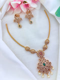 Elegant matte finish peacock motif necklace adorned with AD stones and pearl drops