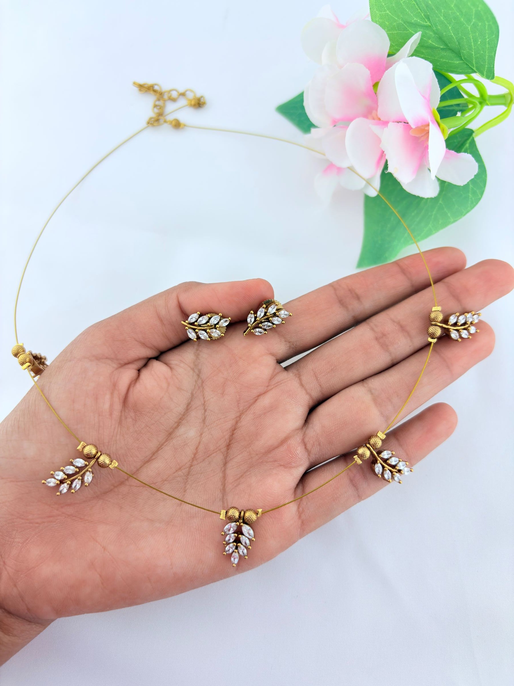 Premium invisible  chain adorned with AD stone leaf pendant