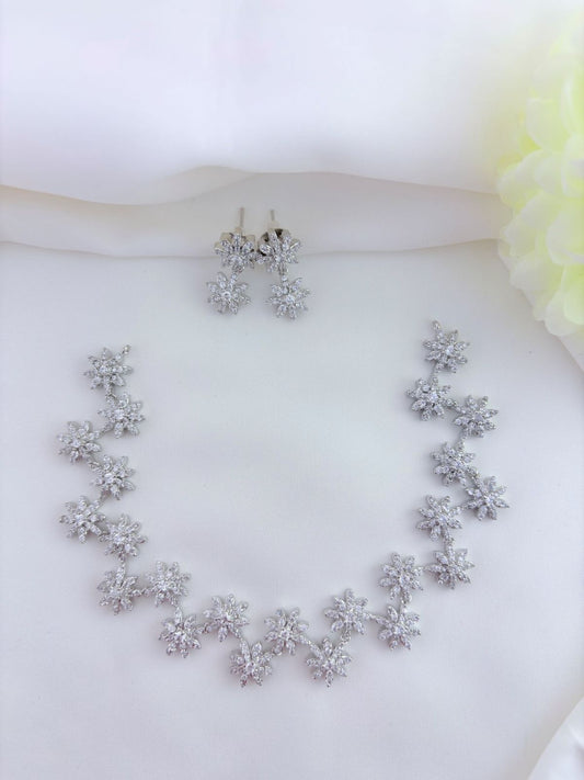 Floral Pattern AD stone neckset in premium silver polish with matching earrings