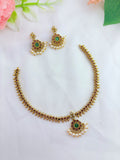 Premium matte finish neckset adorned with ruby and green stones for a rich traditional look