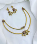 Classic layered necklace showcasing peacock and floral artistry, enriched with stones and highlighted pearl & gold drops