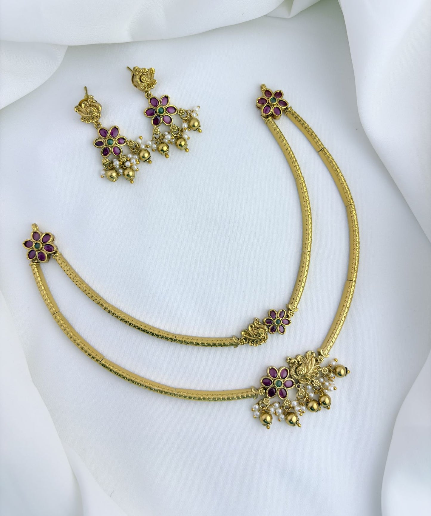Classic layered necklace showcasing peacock and floral artistry, enriched with stones and highlighted pearl & gold drops