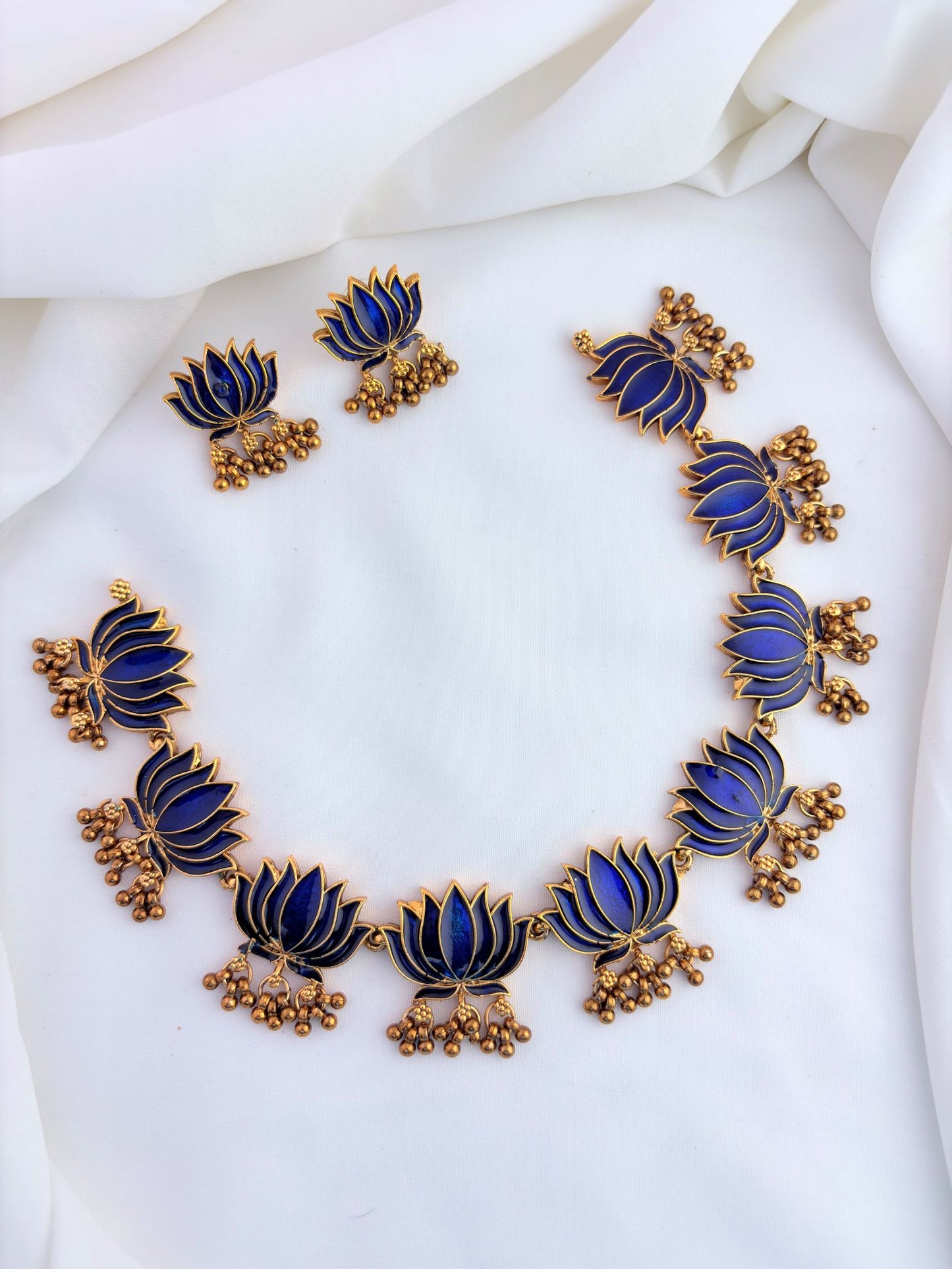 Elegant lotus design necklace set featuring intricate enamel work and matching earrings.